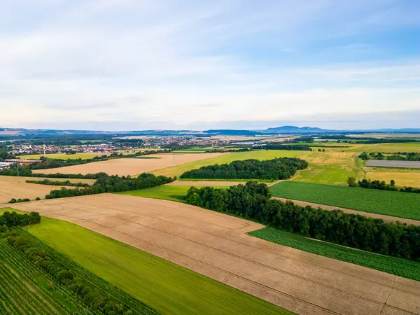 stock image A stunning drone view of Hrusovany u Brna, showcasing the charming town, surrounding vineyards, and a distant, scenic view of the Palava Hills.