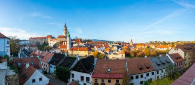 Cesky Krumlov 'un panoramik manzarası, tarihi kale kulesi ve Nepomuk Kilisesi. Ortaçağ kasabasının cazibesi güneşli bir günde çok güzel yakalanır.