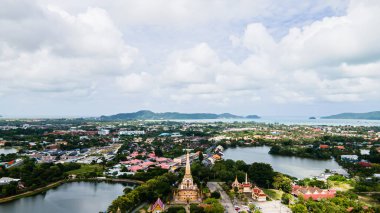 Hava aracı görüntüsü, sırt çantalı gezgin Wat Chalong 'da ya da Tayland' ın Phuket kasabasındaki Chalong tapınağında güzel bir pagoda 'ya seyahat ediyor. Phuket Tayland 'daki en popüler Tayland tapınağı..