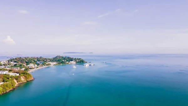 Aerial view of blue water surface background and sun reflection. aerial view of a flying drone Waves surface on a tropical ocean with bright sunlight. Perfect for vacations, in the island of Phuket Thailand.