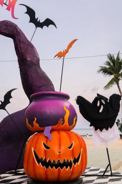 Concept: Halloween beach and ocean background with spider, witch and ghost pumpkin. Dark, scary tone. clipart