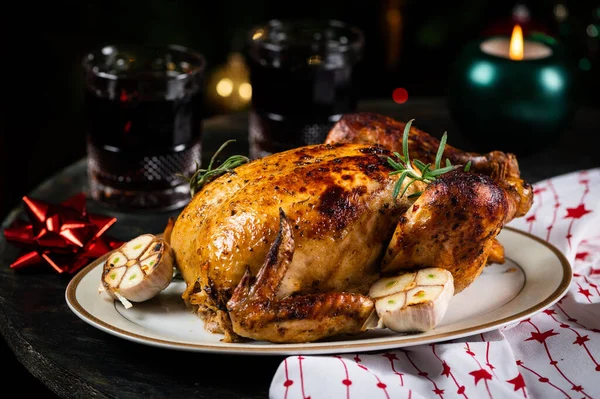 Roasted Turkey. Christmas table served with chicken, decorated with christmas decor and candles. Roasted chicken, table setting. Christmas dinner. New Year dinner