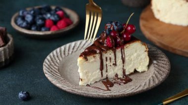 Taking a bite of cheesecake. Eating cheesecake. Piece of San Sebastian Basque Cheesecake with berries. Basque cheesecake. Popular dessert. Burnt cheesecake