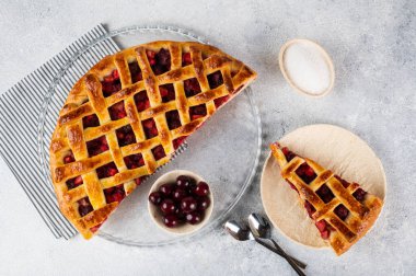 Piece of Cherry Pie with a Flaky Crust on light background. Top view. American pie. Cherry dessert. Flatlay. Cherry filling.