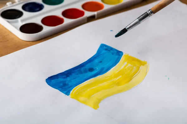 Painting of ukrainian flag. Drawing ukrainian flag. Stop war concept. Patriotic concept. War in Ukraine.