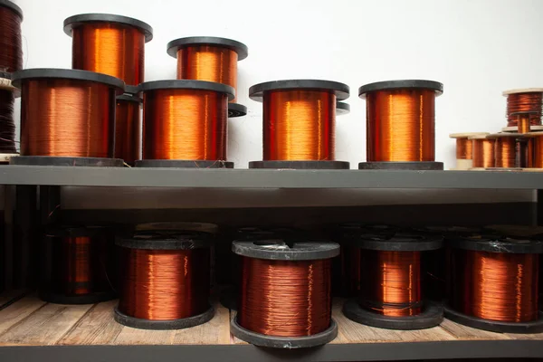 many different coils of copper wire in the production workshop, winding copper cable on spools