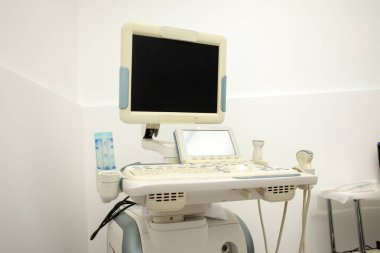 modern ultrasound machine in a hospital on a white background with a blank screen, medical equipment
