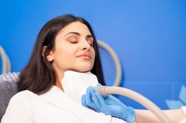 coolsculpting procedure in cosmetology clinic, cosmetologist doctor makes procedure for removing fat from the chin to patient clipart