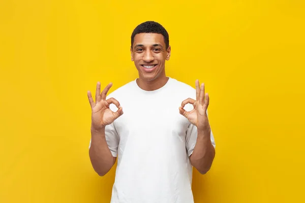 Young African American Guy White Shirt Shows Gesture Yellow Isolated — Stock Photo, Image