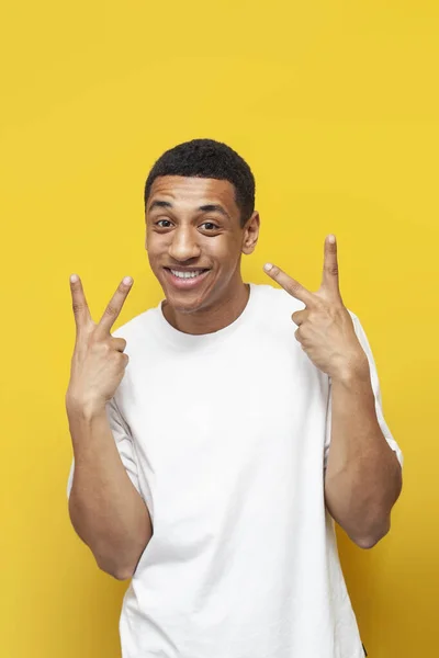 Young African American Guy White Shirt Shows Peace Gesture His — Stock Photo, Image