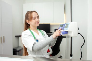 portrait of a nurse girl in a medical gown in a hospital, a female doctor in uniform against the background of the workplace