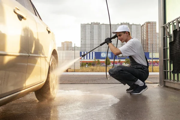 Νεαρός Στολή Εργάτη Πλυντηρίου Αυτοκινήτων Πλένει Αυτοκίνητο Νερό Από Λάστιχο — Φωτογραφία Αρχείου