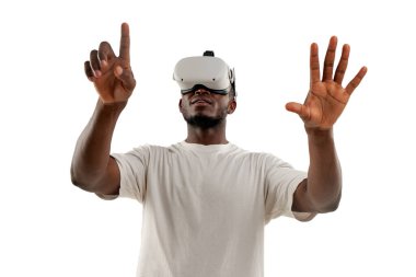 african american man plays video games in virtual reality glasses and touches with his hand on white isolated background, the guy looks in vr glasses to the side chooses and points with his finger clipart