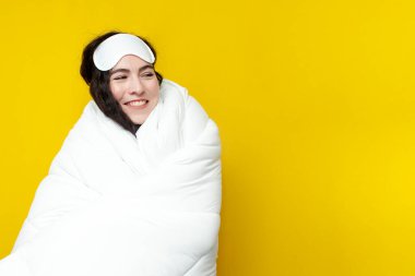 Tatlı, genç bir kız uyku maskesi takmış, kendini yumuşak halıyla kaplamış ve fotokopi odasına bakıyor, kadın yatmaya hazır, yumuşak, rahat yatak örtüsü konsepti.