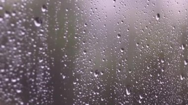 Fırtınalı bir günde pencereden düşen yağmur damlaları. Seçici odak
