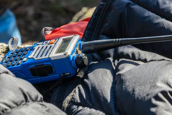 stock image close-up of a used walkie talkie radio with keyboard over warm clothing on a sunny winter day. Adventure, exploration concept