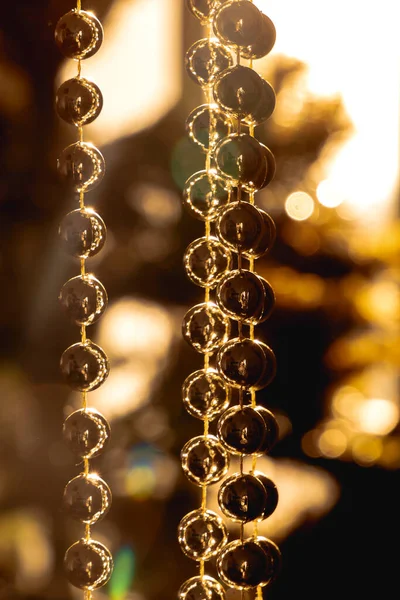 Close up of a garland of glittering golden pearls for Christmas decorations
