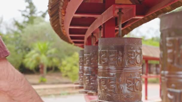 Slow Motion Crop Anonymous Man Spinning Buddhist Prayer Wheels Carved — Stock Video