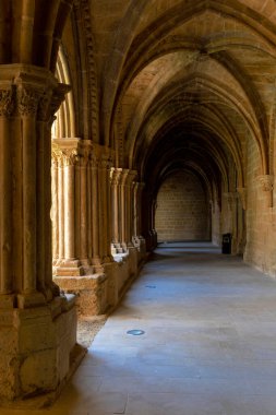Kemerli tavanları ve sütunları olan uzun, dar bir koridor. Işık kemerlerin arasından parlıyor, sıcak ve davetkar bir atmosfer yaratıyor. Ortaçağ mimarisi. Sarnıç Sanat Biçimi