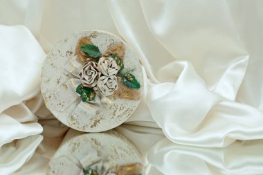 White cardboard jewel case with paper roses