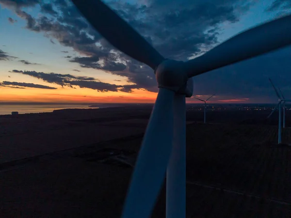 Wind turbine at sunset close-up drone view