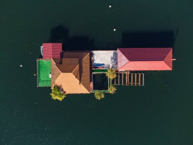 Aerial top view of a floating house in Vacha Dam, Devin Municipality, Bulgaria