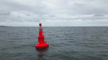 Fırtınalı denizde bulutlu ağır çekimde kırmızı seyir şamandırası