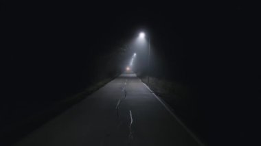 A trip on a rural forest road in a fog at night, flying drone video