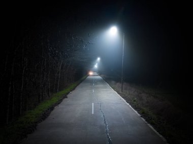 A trip on a rural forest road in a fog at night, flying drone photo