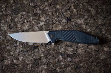 Jackknife or flick-knife on cork tree background, extreme close up.