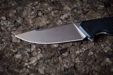 Jackknife or flick-knife on cork tree background, extreme close up.