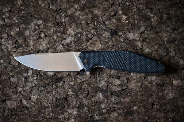 Jackknife or flick-knife on cork tree background, extreme close up.