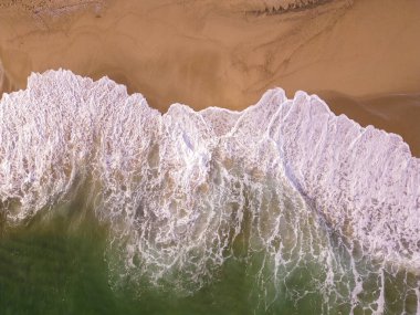 aerial top down view on a sandy beach with sea surf no people