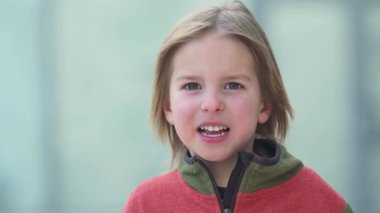 Portrait of cute 5 years old little boy looking to the camera and smiling