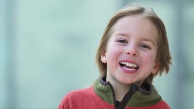 Portrait of cute 5 years old little boy looking to the camera and smiling