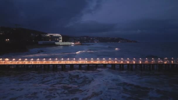 Illuminated Pier Dramatic Sky Stormy Dark Sea Evening Aerial View — Video