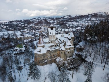 The snow covered medieval Castle of Bran, known for the castle of Dracula. Transylvania. Romania. Aerial view