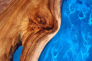 Texture of a wooden table with epoxy resin closeup