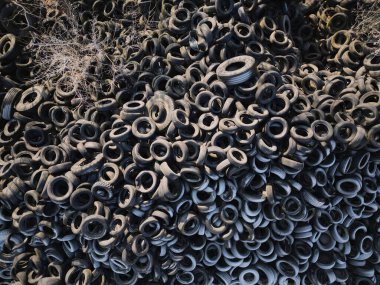 Aerial top down view of old tires. Many car and truck tires on dump site from above