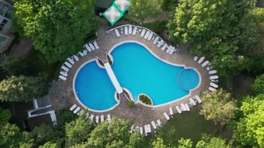 Aerial top view of beautiful luxury outdoor swimming pool in hotel resort