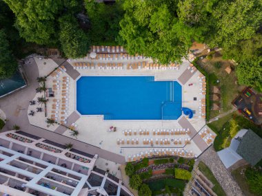 Aerial top view of beautiful luxury outdoor swimming pool in hotel resort