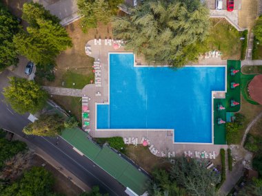 Aerial top view of beautiful luxury outdoor swimming pool in hotel resort