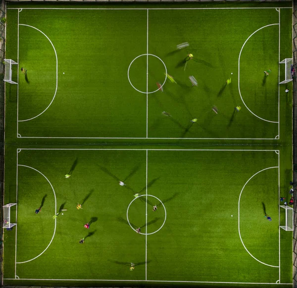 Aerial top view of a mini football match, soccer. MiniFootball field and Footballers from drone