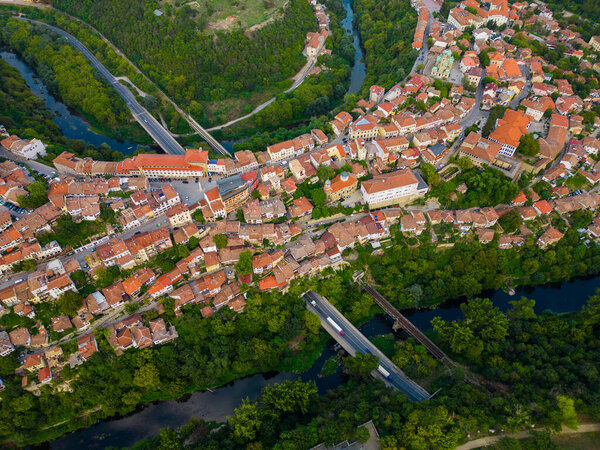 An aerial view of Veliko Tarnovo reveals a Bulgarian city rich in history and culture, with its beautiful buildings, streets, and picturesque hills. Summer evening.