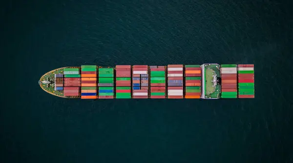 A loaded container ship in the sea, aerial top view, concept of international trade and shipping