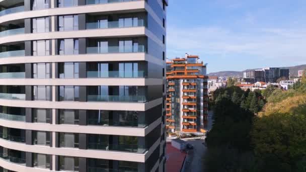 近代的なオフィスや住宅の建物の背景のファサードに沿ってドローン飛行 — ストック動画