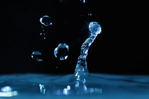 The process of boiling water, a stream of water shooting out of a humidifier or diffuser taken in close-up.