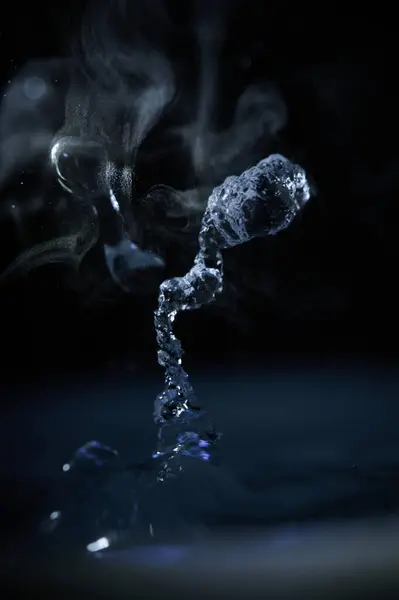 The process of boiling water, a stream of water shooting out of a humidifier or diffuser taken in close-up.