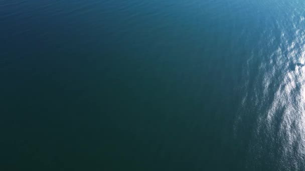 柔らかい光の下で海の静かで問題のない表面を捉えるオーバーヘッドショット — ストック動画