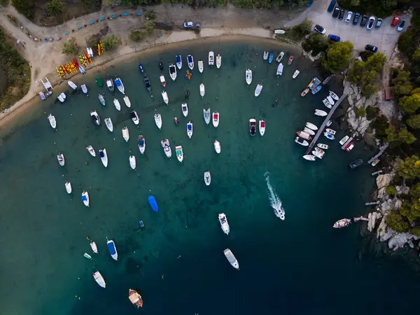 stock image Aerial view of a vibrant marina in Sithonia, Greece, filled with various boats and yachts docked along the shore, capturing the lively and scenic atmosphere of a coastal harbor.